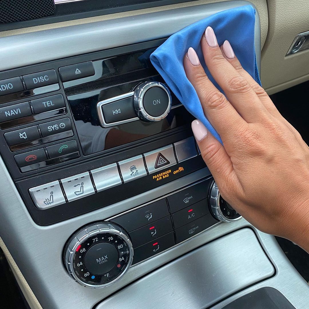 cleaning car dashboard with cleaning products