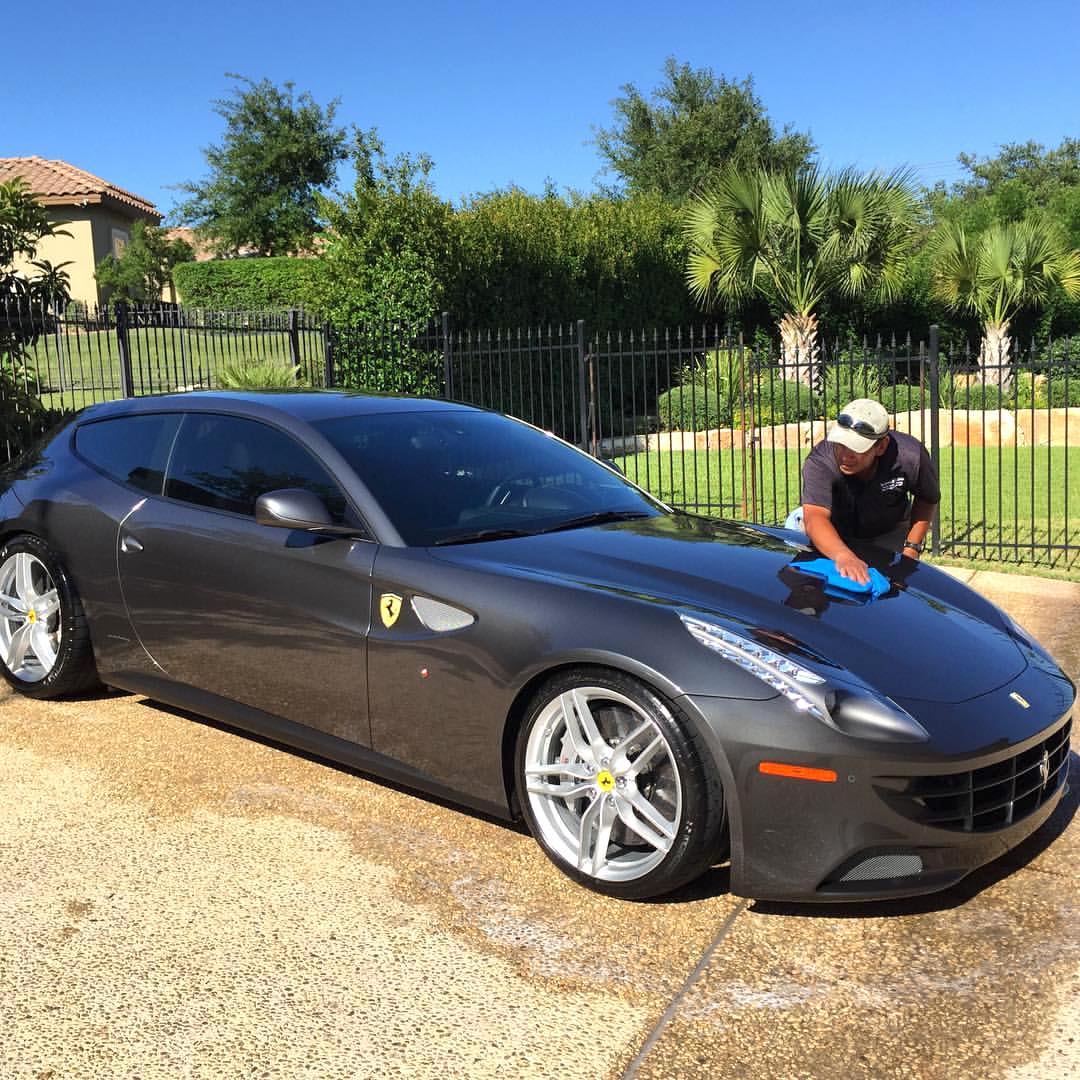 man cleaning his ferrari with absorber towel